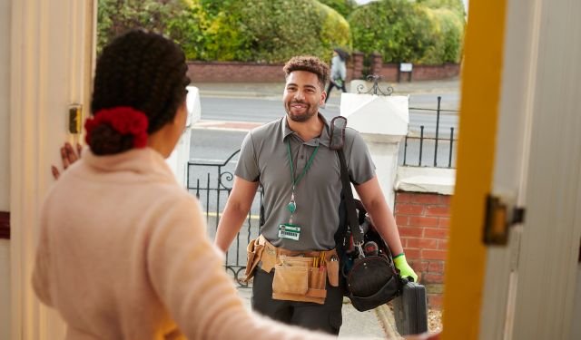 menuimage a man in tool belt and a bag talking to a woman